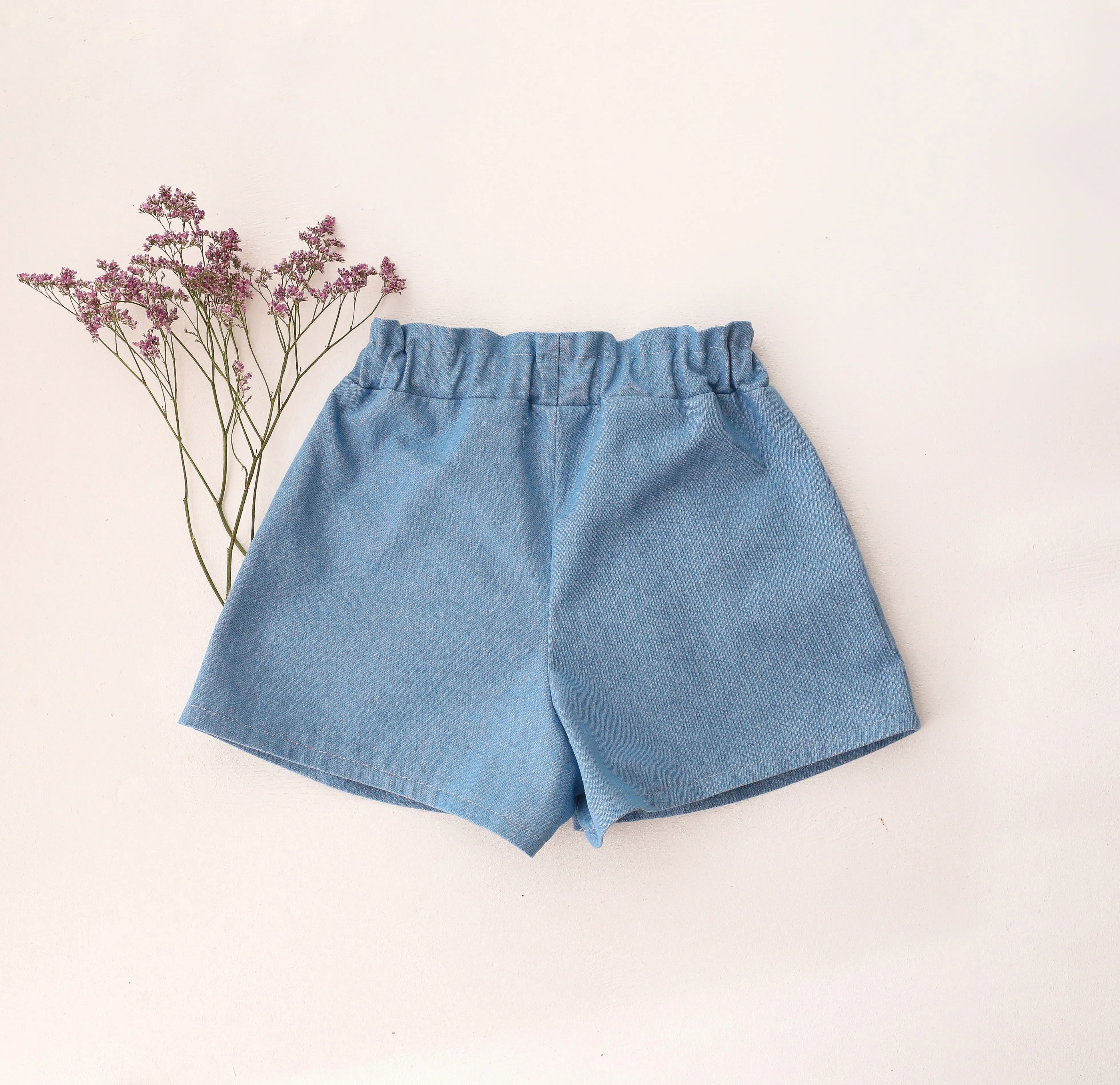 Light Blue Denim Paperbag Waist Shorts with "Wild Bells" Embroidery